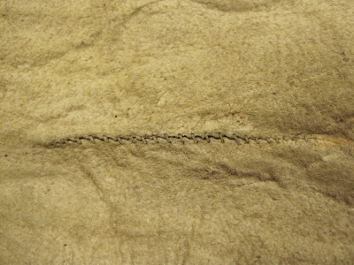 1893.67.3 - detail showing stitched repairs on the body of the shirt