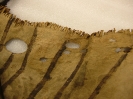 1893.67.1 - close up showing the holes for the pegs used in the leather tanning process