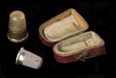 1961.2.038 and 1961.2.039 Thimbles (the silver one is a child's) and box donated by Canziani