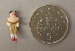 1944.7.61 The doll set beside an English 5p coin for scale. Photographs taken with microscope camera by Conservation Department