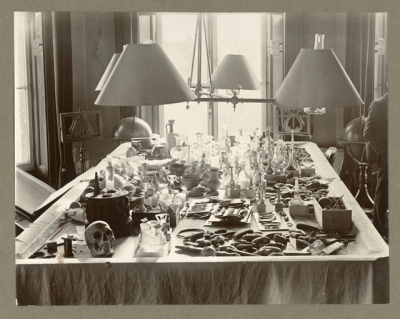 Artefacts on the table in the Billiard Room, Rushmore. 2002.73.14