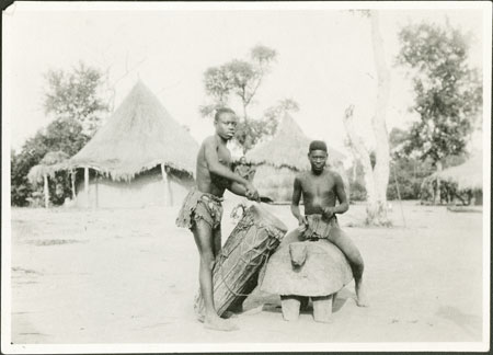 Zande youths with drum and gong