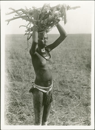 Nuer woman carrying firewood
