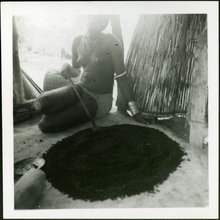 Mandari woman preparing food