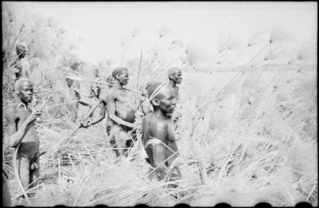 Nuer men watching hippo hunt