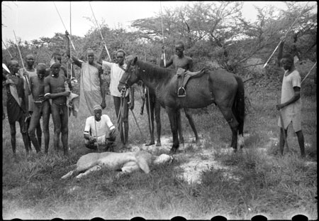 Nuer porters with lion