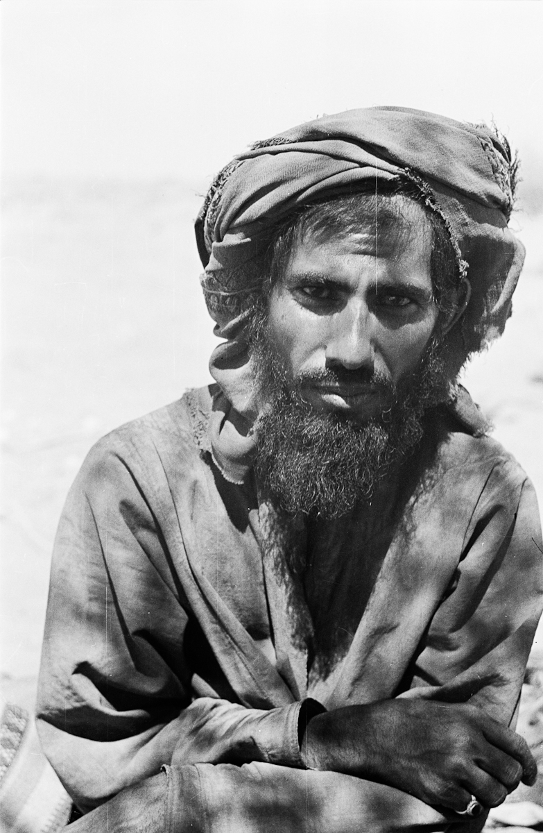 Half length portrait of Muhammad bin Kalut, one of Wilfred Thesiger's Bedouin companions, in the area west of the Hamrat ad Duru region.