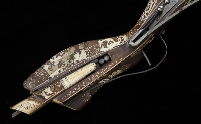 Close-up stocking the stock of the Tschinke rifle