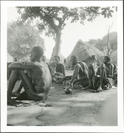 Anuak men smoking pipes