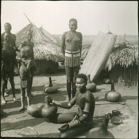 Mandari Kbora woman churning milk